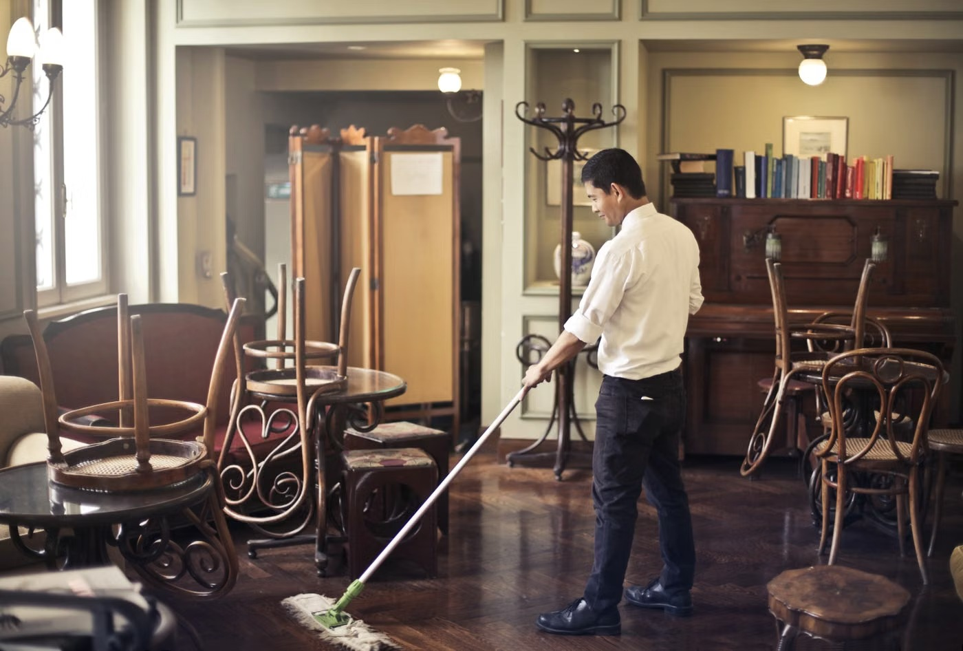 Illustrative stock photo of a worker mopping a commercial dining space