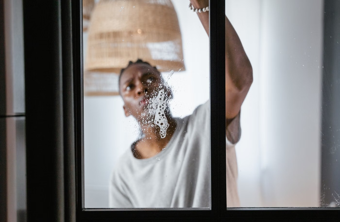 Illustrative stock photo of a man washing a window